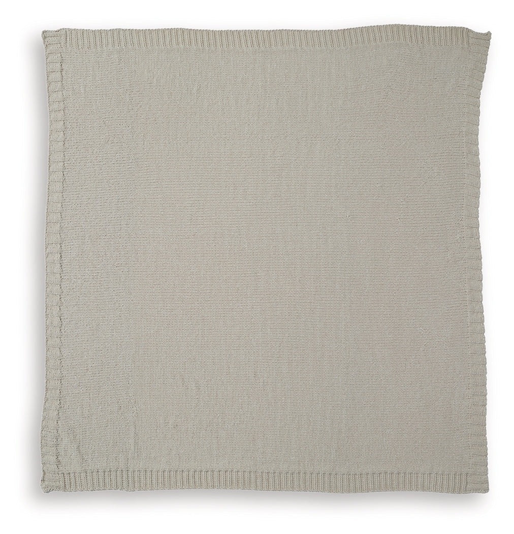 Anawood throw blanket draped over bed corner