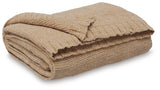 Close-up of gold chenille fabric texture on throw