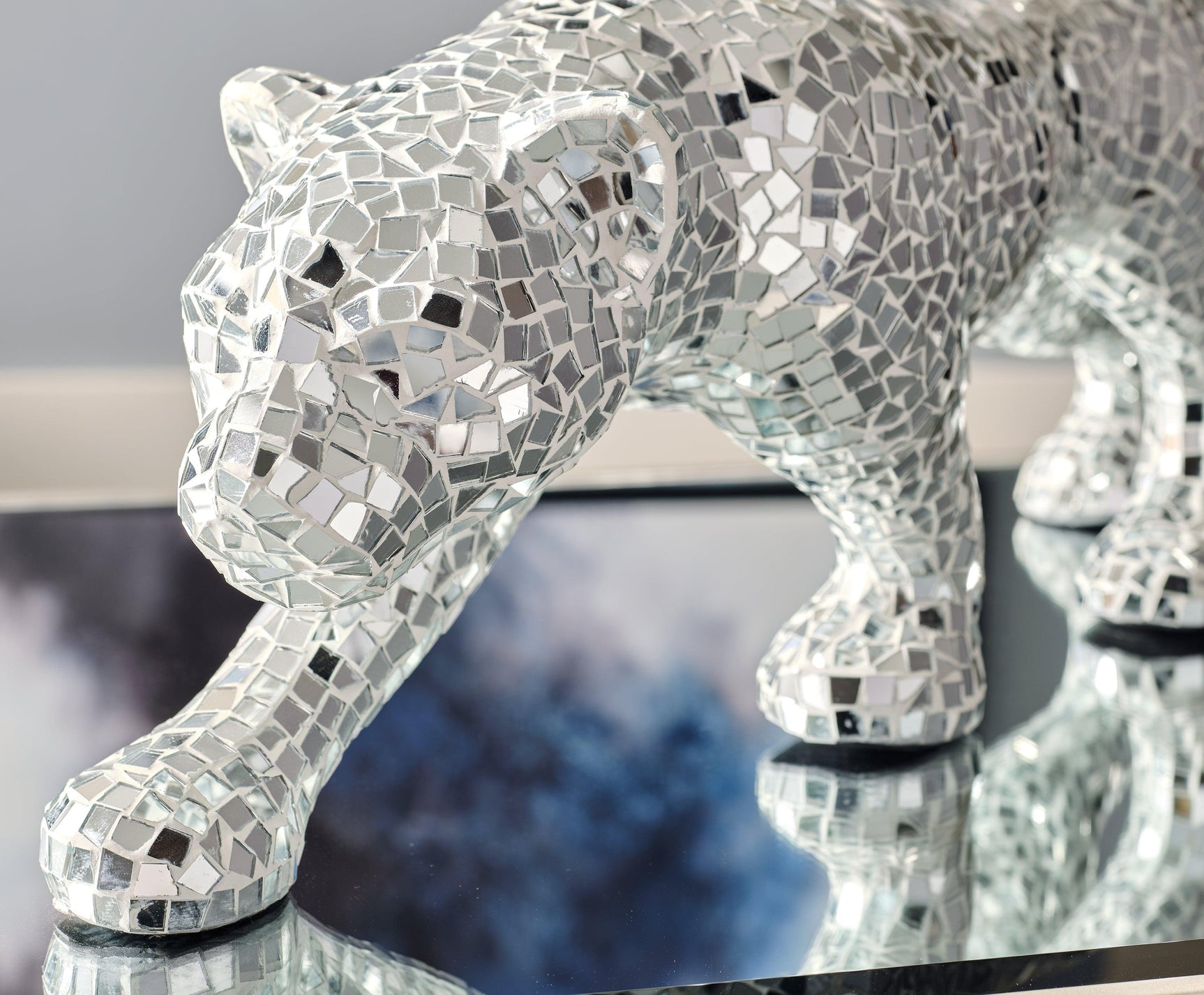 Detailed view of Drice panther sculpture mosaic and mirrored surfaces