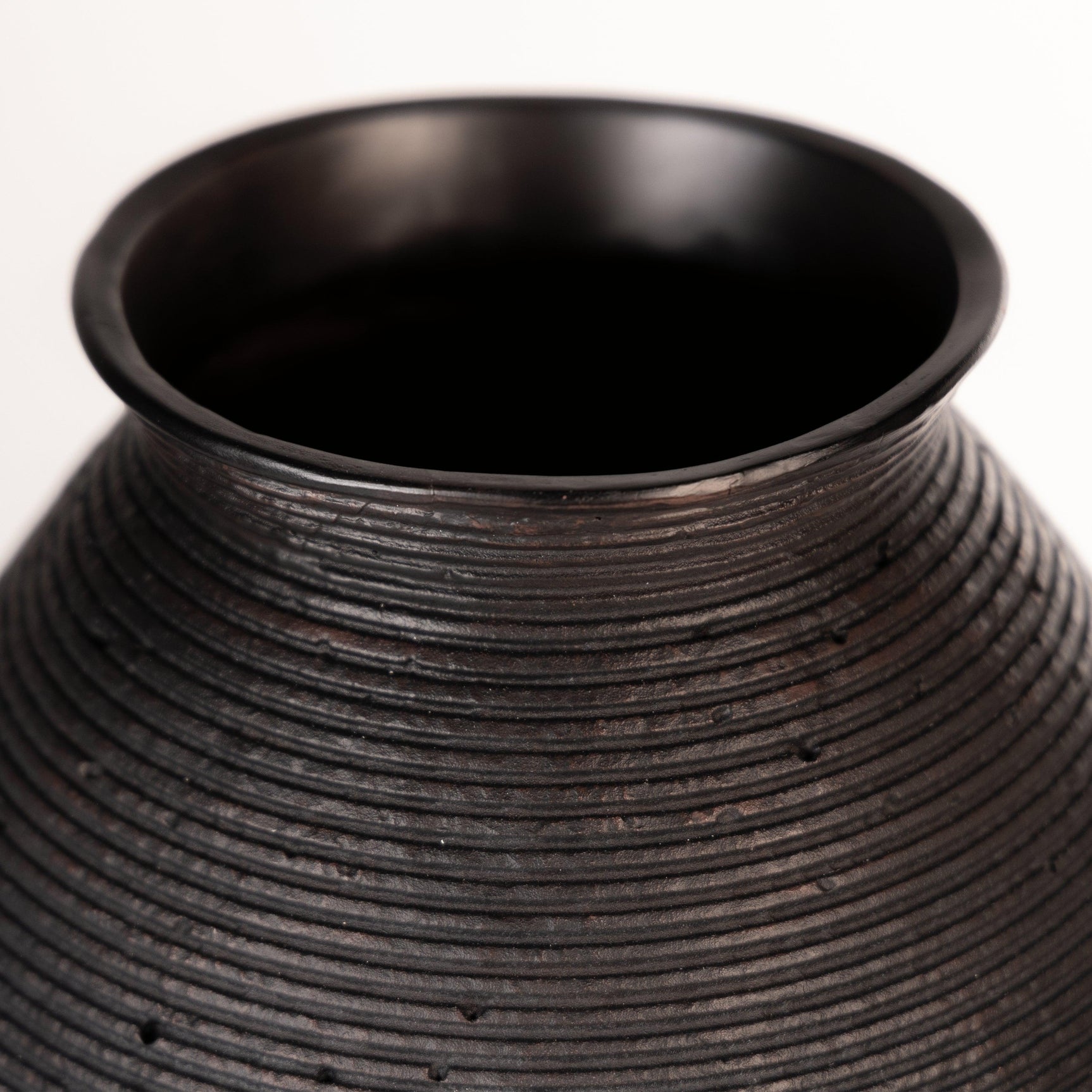 Close-up of antiqued brown finish on Hannela Vase