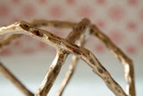 Close-up of antique brass finish texture on Laddington sculpture