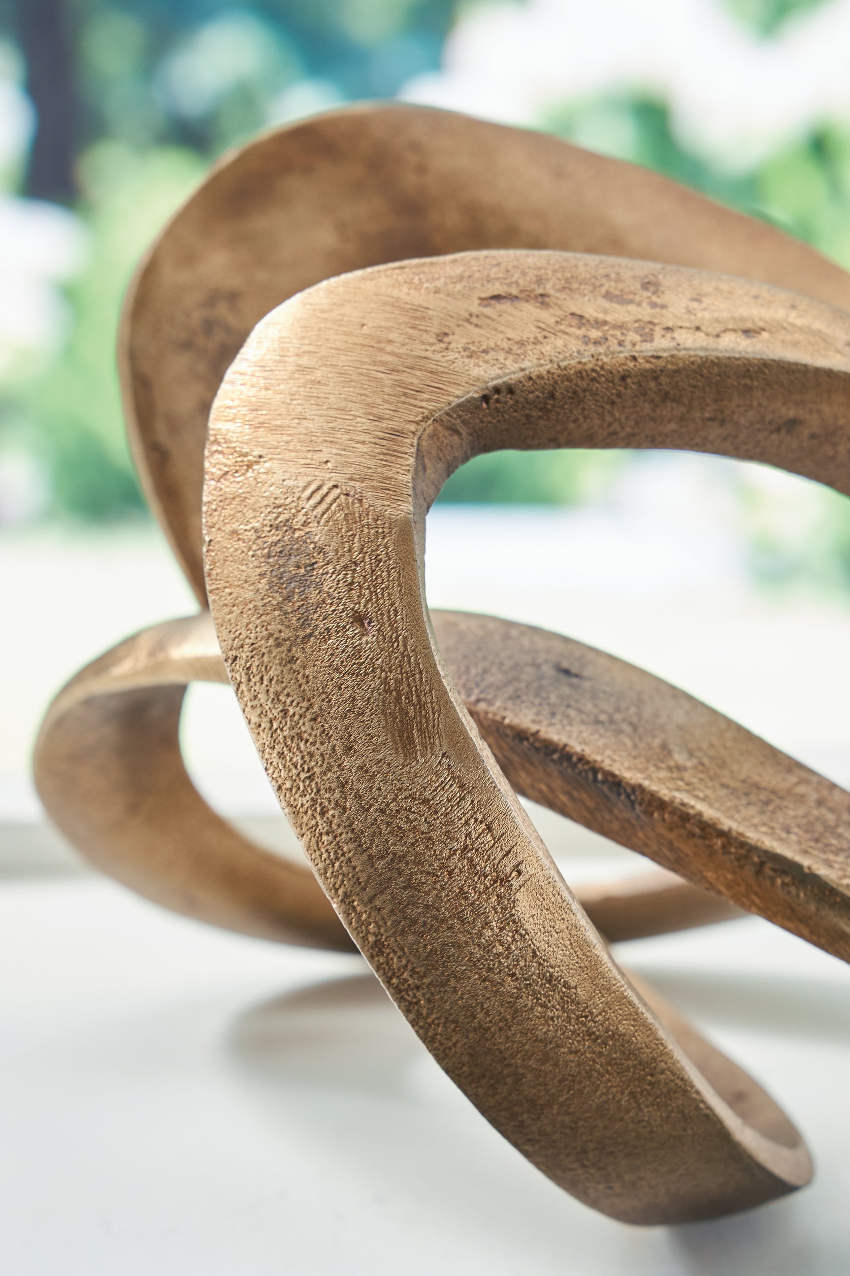 Finish detail of Dunnruck sculpture showing antique brass texture