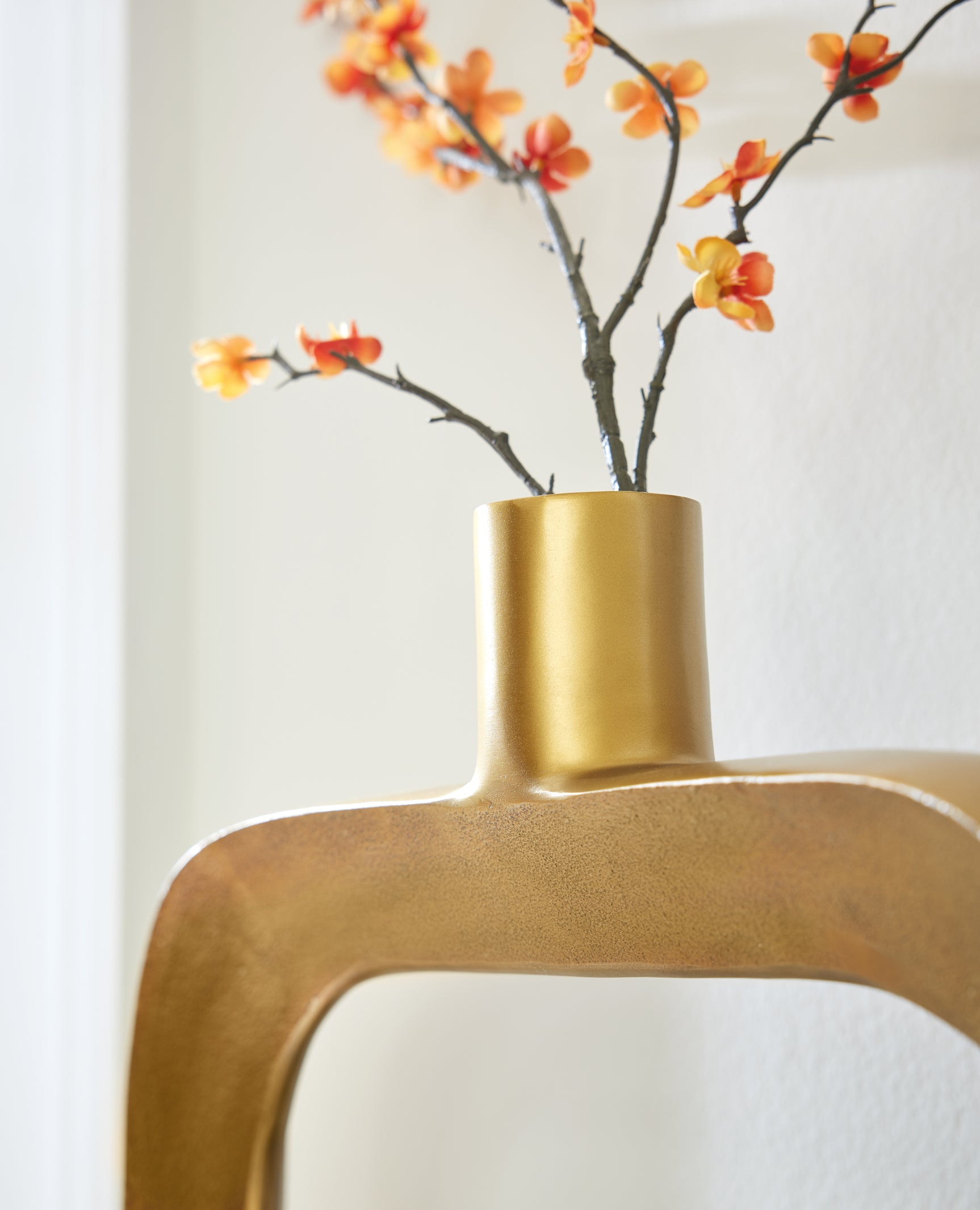 Detail of oval shape and goldtone finish on vase