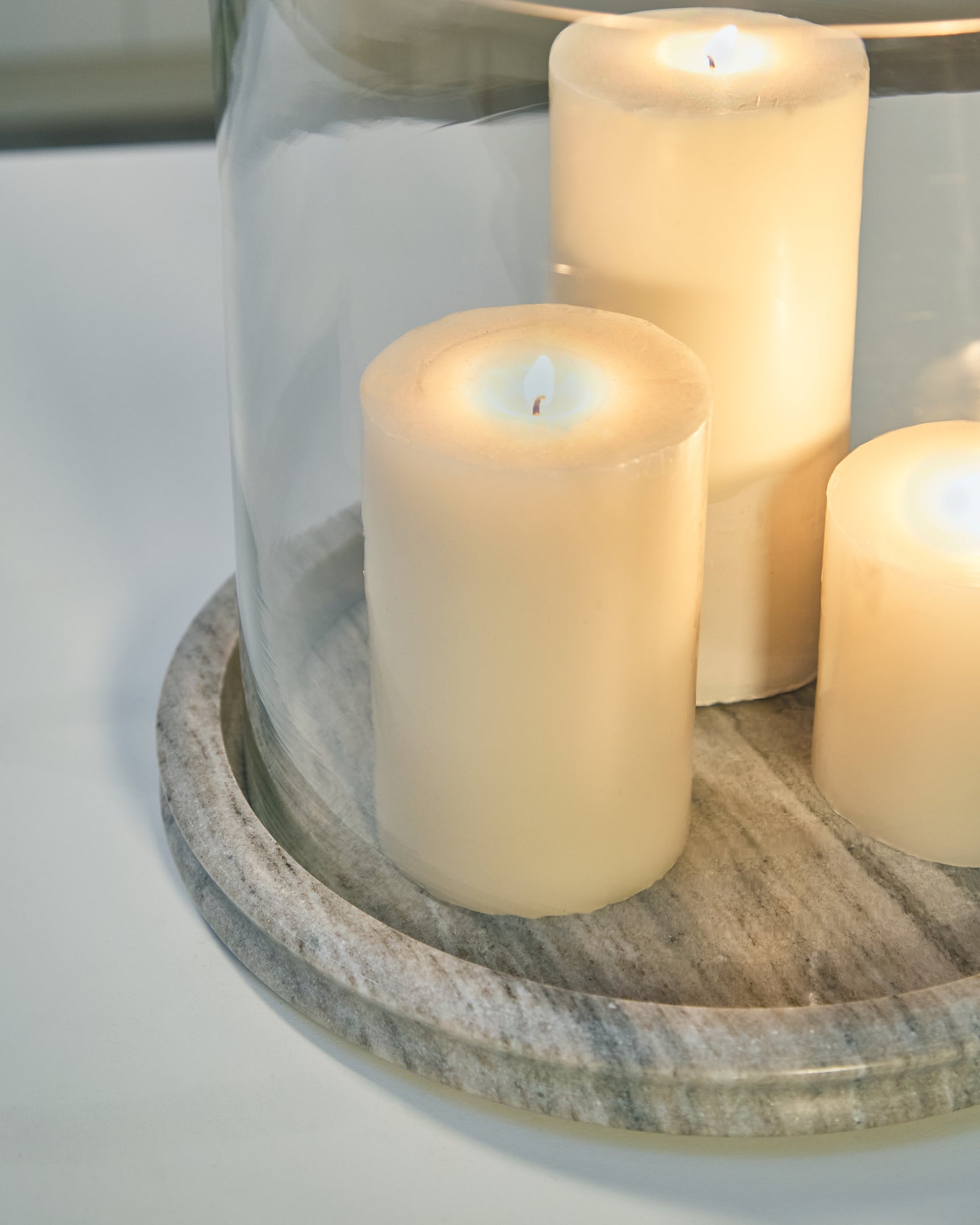 Close-up detail of beige marble base on Saskia candle holder