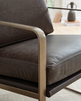 Detail view of gold metal frame and upholstery