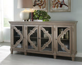 Fossil Ridge Gray Accent Cabinet front view showing quatrefoil glass doors