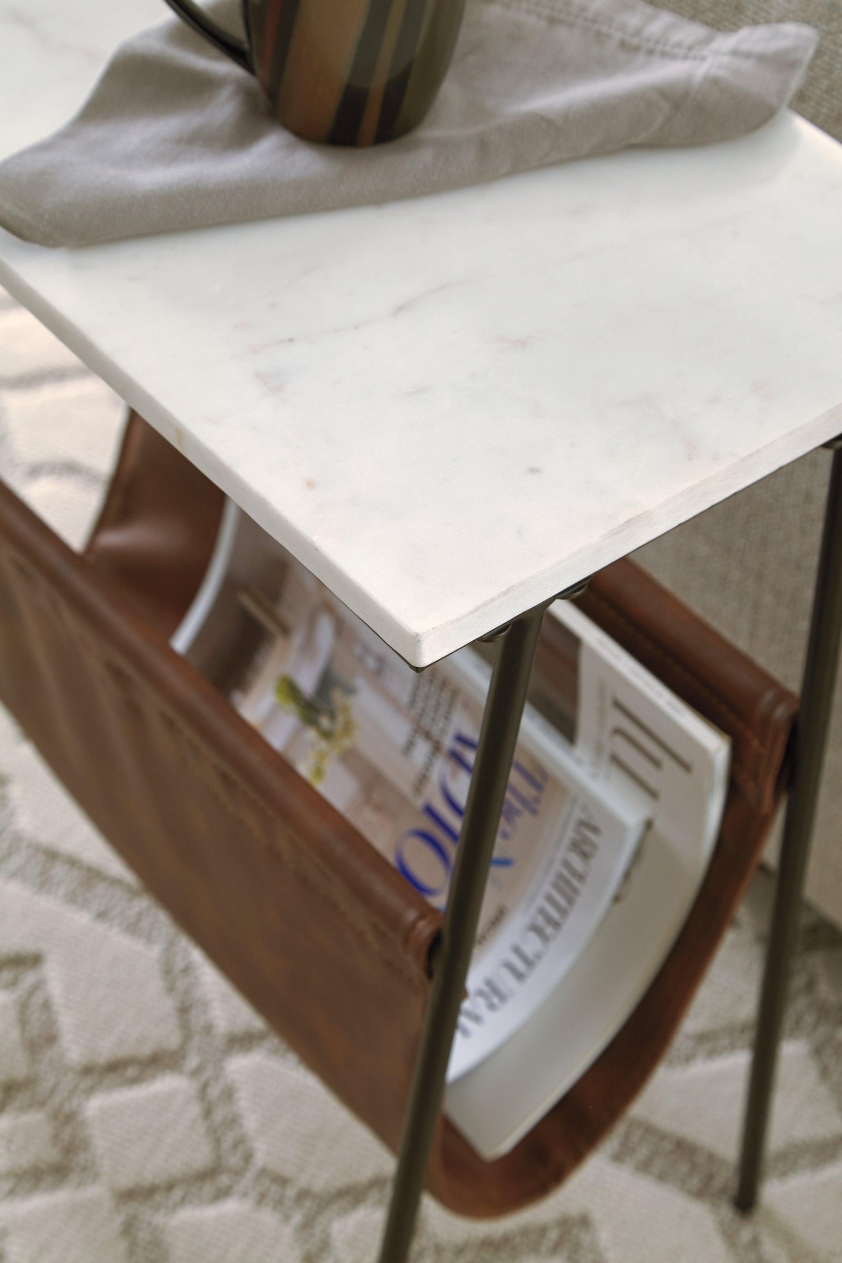 Close-up of Etanbury Accent Table magazine holder in brown faux leather