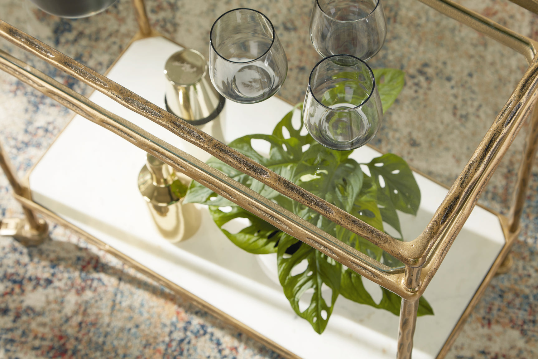 Detail of white marble lower shelf on bar cart