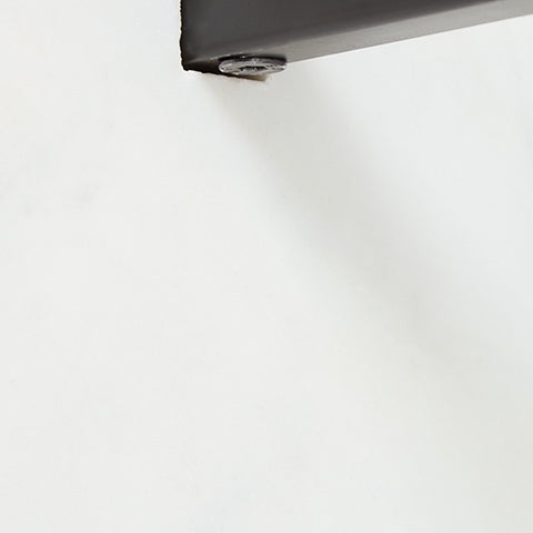 Finish close-up showing smooth black metal and marble surface