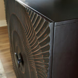 Close-up of carved sunburst pattern on door