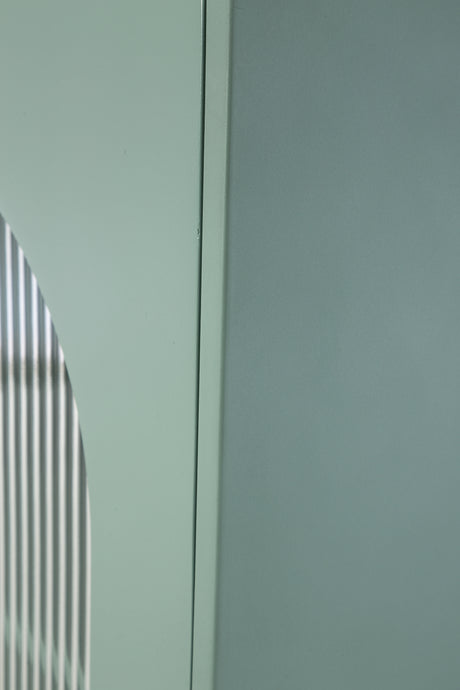 Detail of light green finish texture on Adwen cabinet