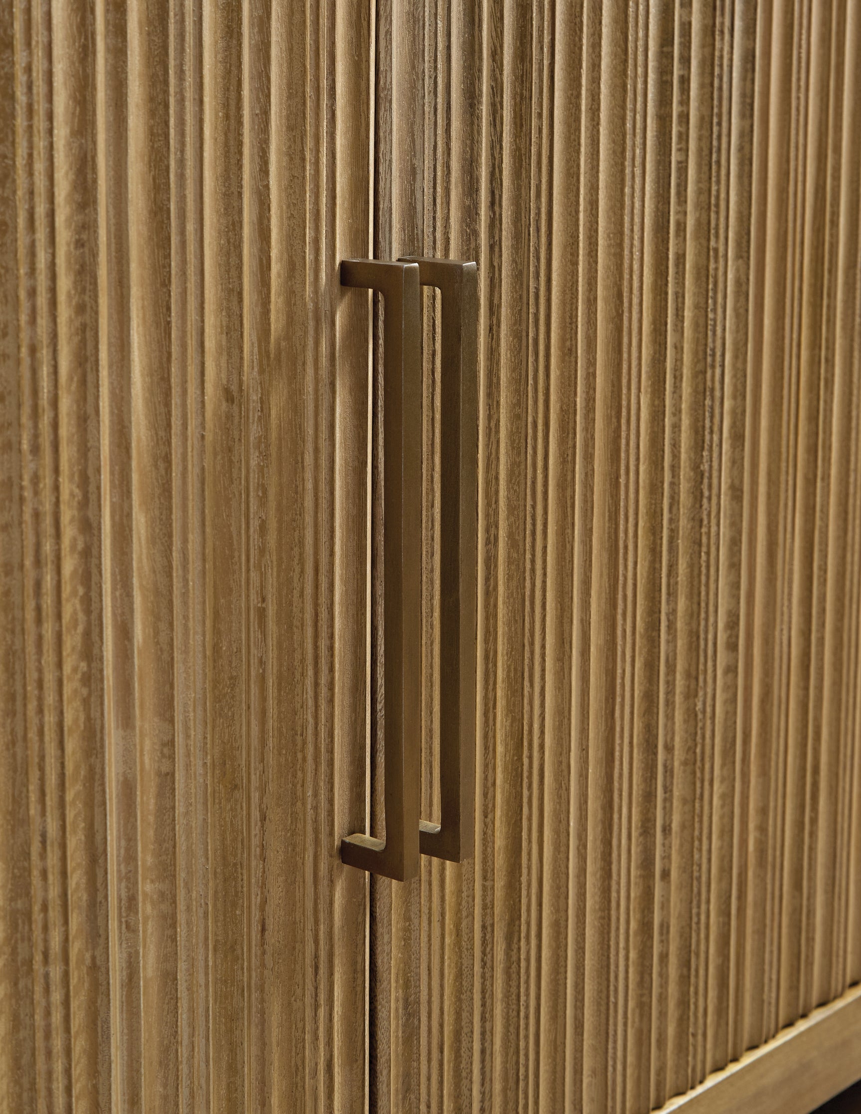 Close-up of antiqued goldtone metal door pull