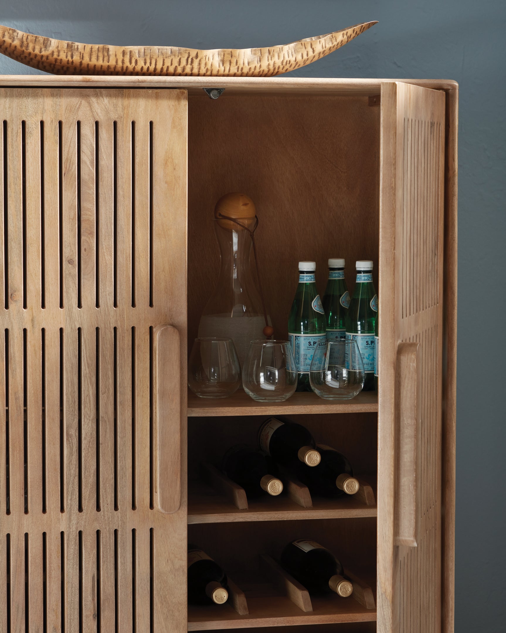 Close-up of mango wood grain finish and door pull detail
