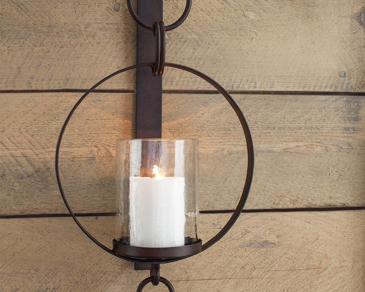 Ogaleesha Brown Wall Sconce front view showing bronze-tone metal frame and clear glass shade