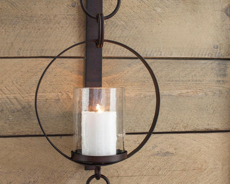 Ogaleesha Brown Wall Sconce front view showing bronze-tone metal frame and clear glass shade