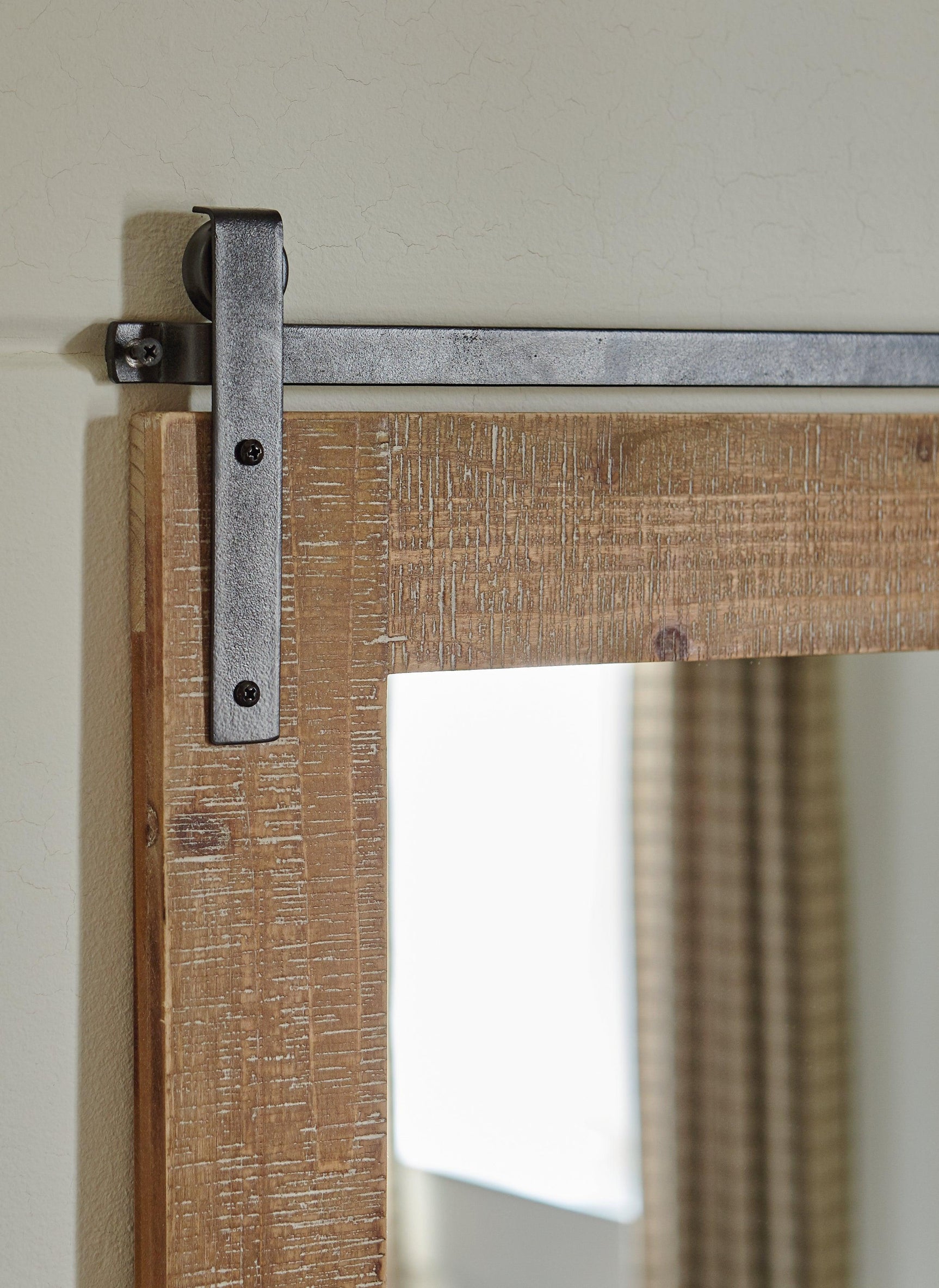 Black metal barn door track on Lanie mirror frame
