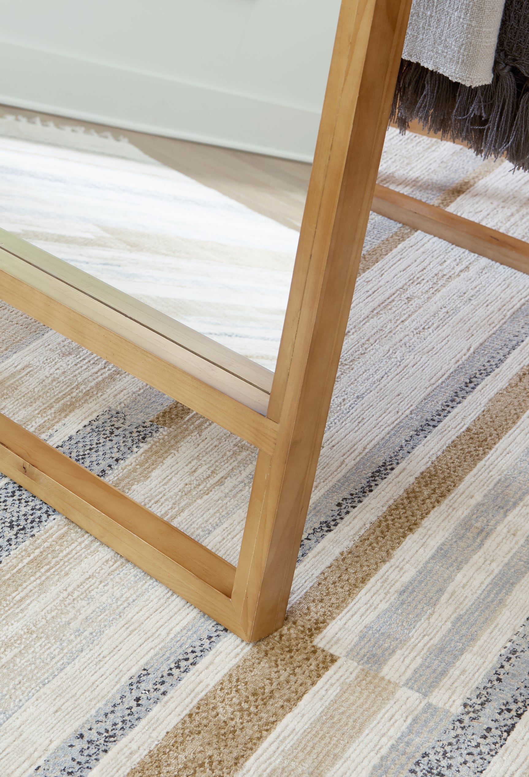 Close-up detail of the brown wood finish on Devford floor mirror