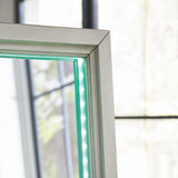 Green lighting illuminating mirror frame