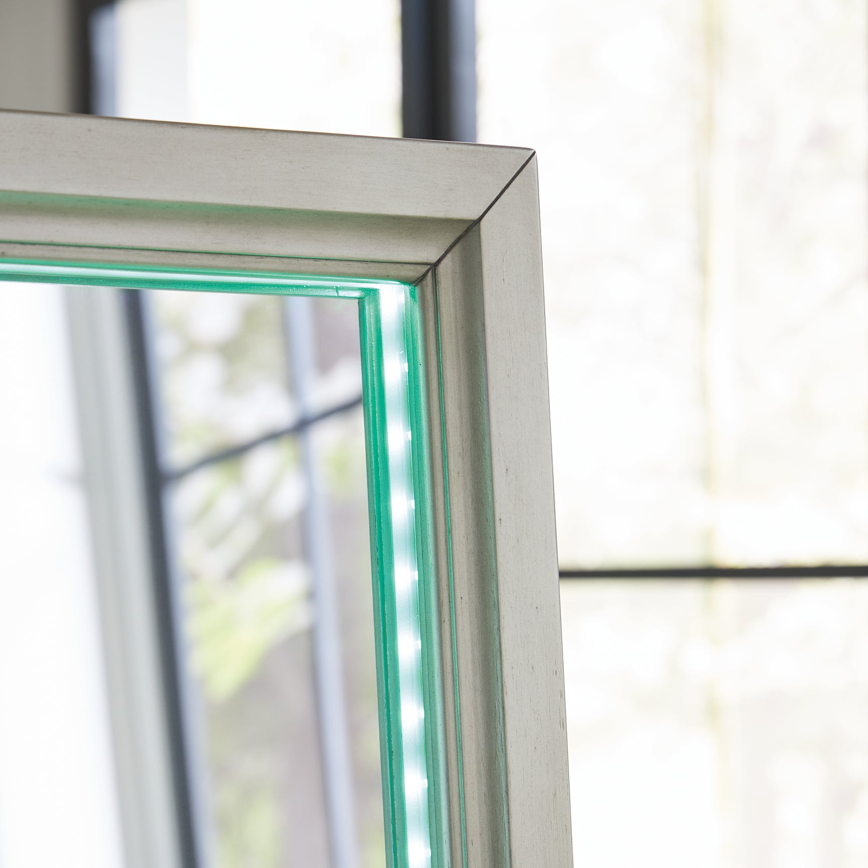 Green lighting illuminating mirror frame
