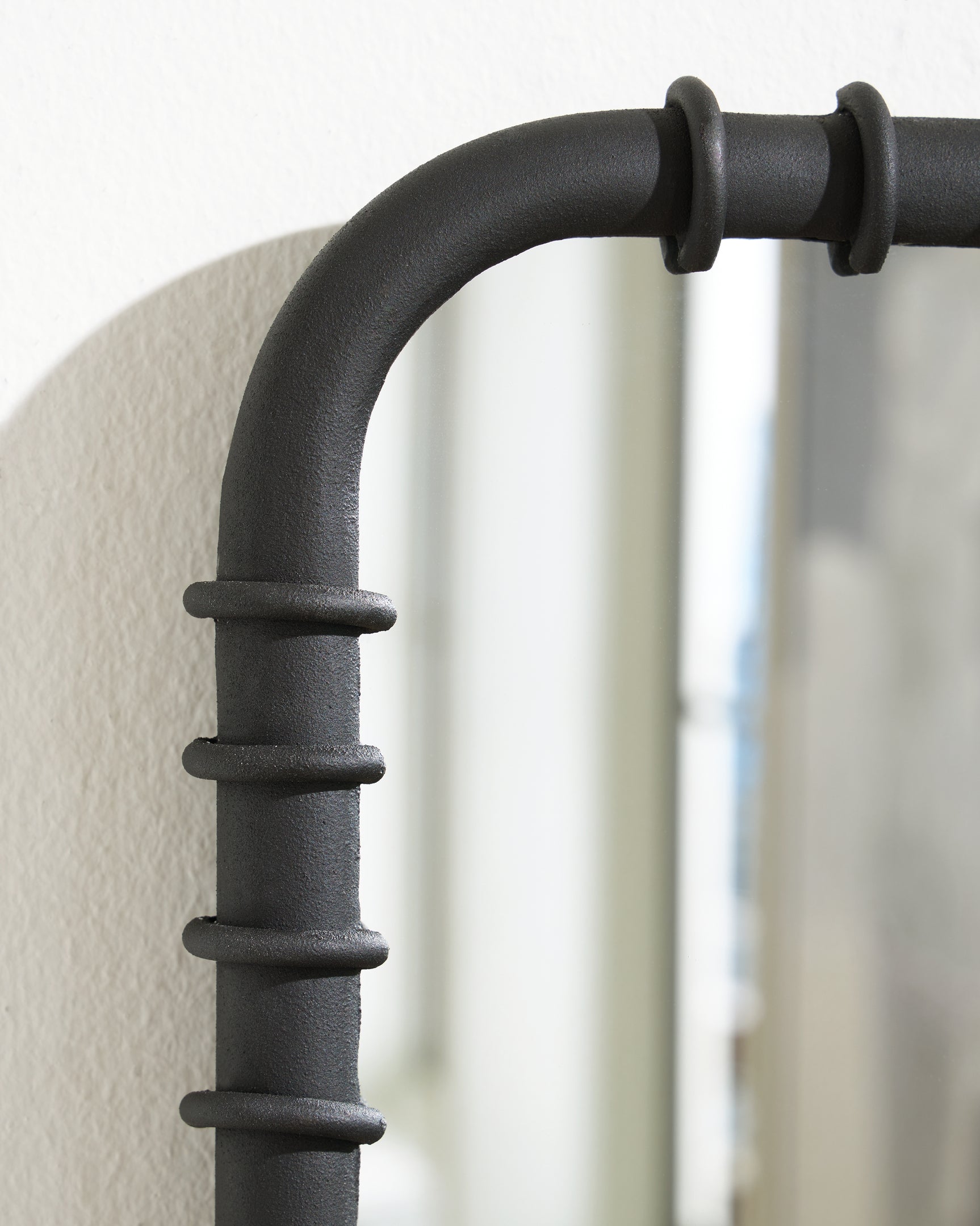Detail view of metal ribbed texture on Judlow accent mirror
