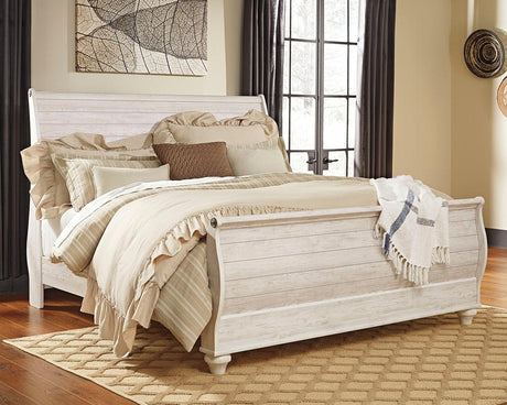 Willowton Whitewash King Sleigh Bed angled view in bedroom