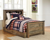 Trinell Brown Twin Bookcase Bed styled with bedding and decorative items