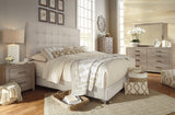 Dolante Beige King Upholstered Bed assembly parts behind headboard