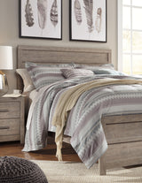 Culverbach Gray King Panel Bed styled in bedroom setting