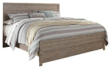 Side angle of Culverbach Gray King Panel Bed showing footboard drawers