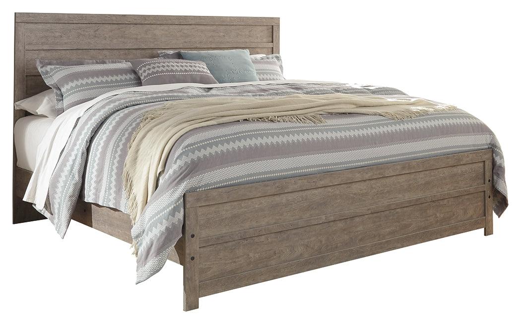 Side angle of Culverbach Gray King Panel Bed showing footboard drawers
