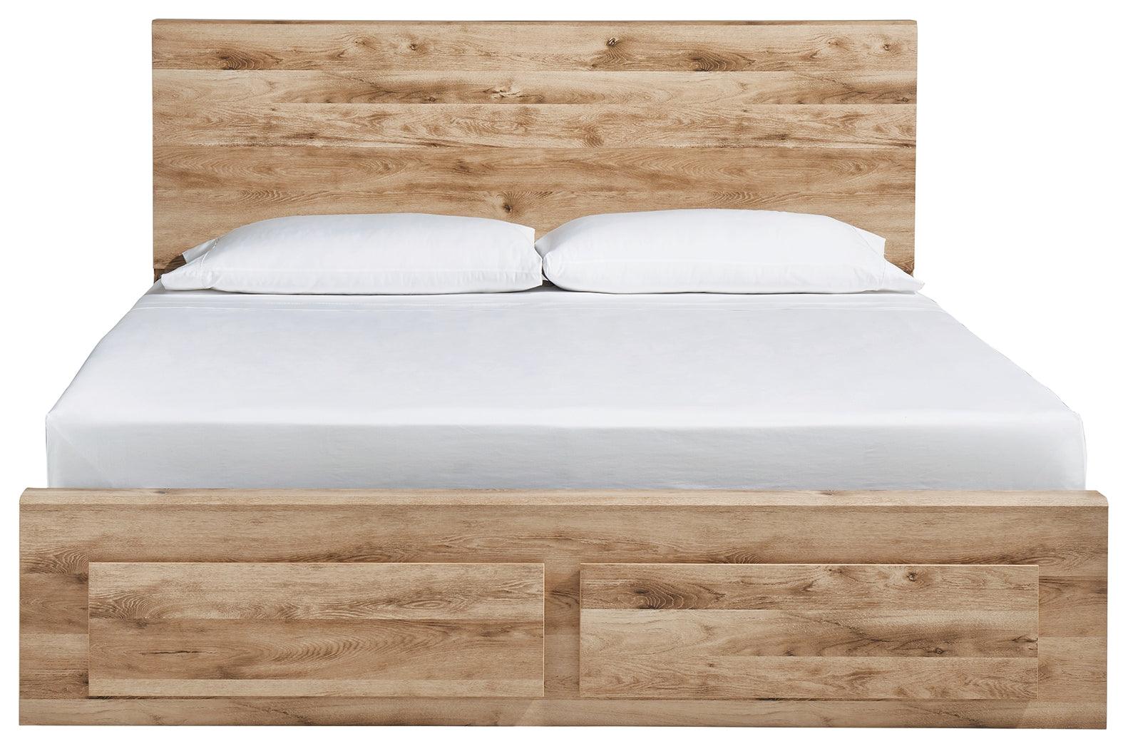 Footboard with two storage drawers open on Hyanna queen bed