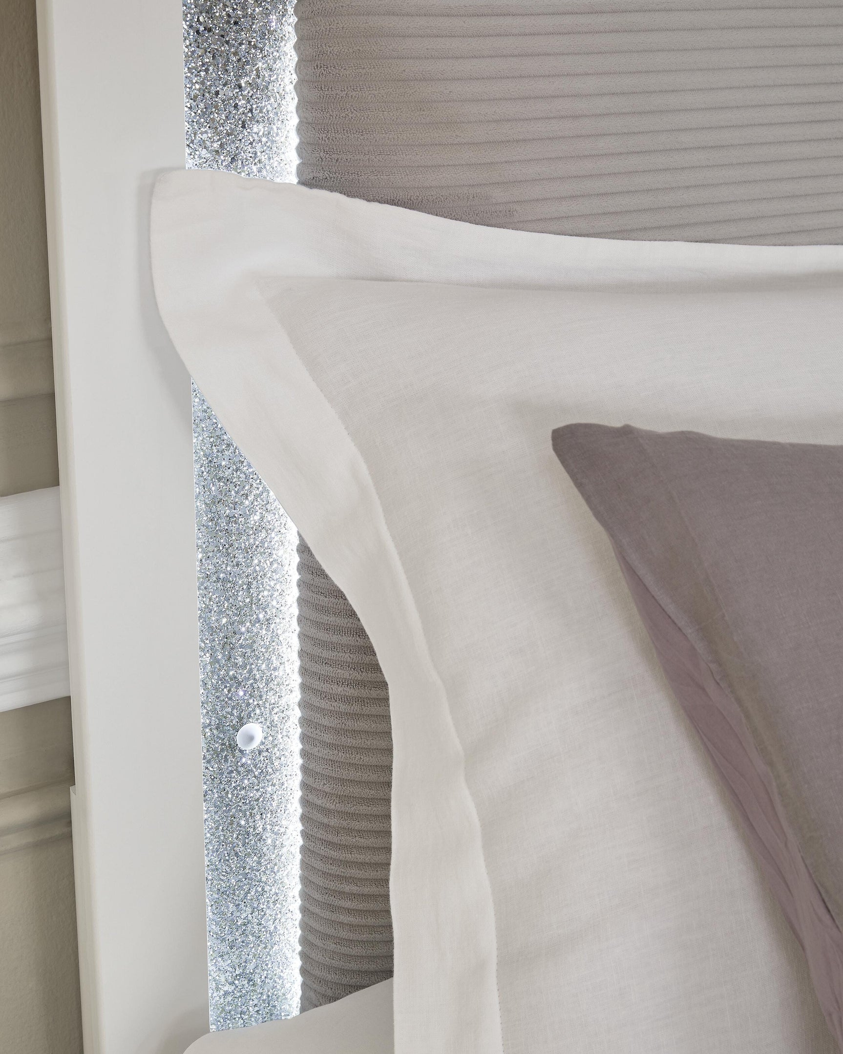 Texture detail of matte white finish on bed