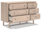 Dresser drawer close-up with black knobs and botanical detail