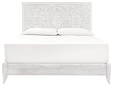 Close-up of Paxberry King Panel Bed carved medallion pattern on headboard