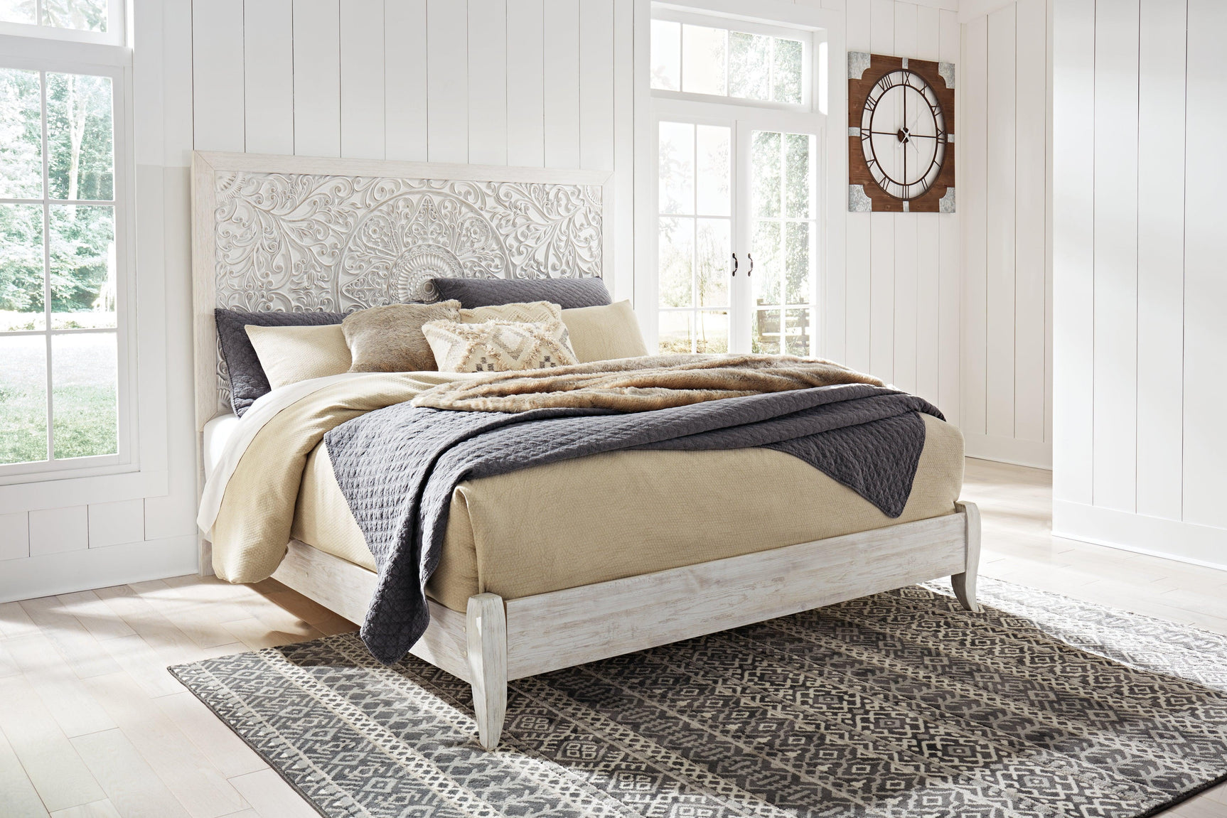 Full view of Paxberry Whitewash King Panel Bed assembled in bedroom