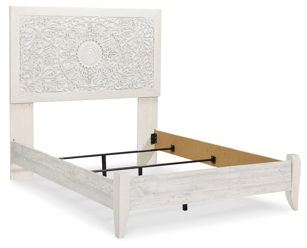 Close-up of Paxberry bed carved medallion pattern headboard