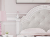 Detailed view of upholstery and button tufting on headboard