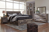 Assembled Derekson King Bed in bedroom setting with linens