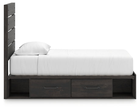 Bed fully assembled with bedding on Hollivern twin bed