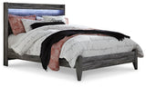 Side view of Baystorm Gray Queen Panel Bed emphasizing storage drawers
