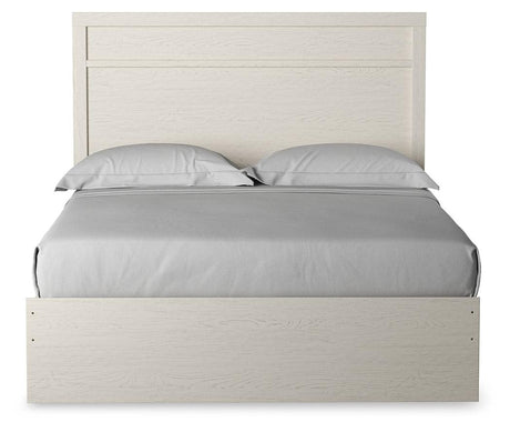 Side view of Stelsie White Queen Panel Bed highlighting storage drawers