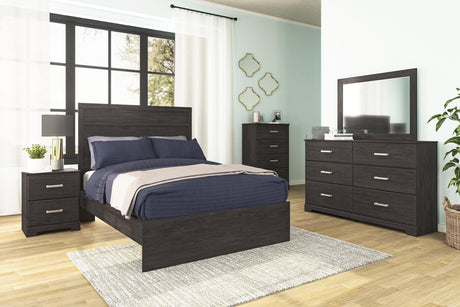 Belachime Black dresser with mirror in bedroom setting showcasing styling
