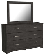 Side angled view of folded dresser drawers in Belachime Black set