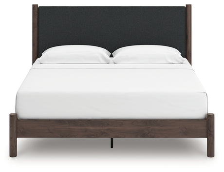 Front view of upholstered panel headboard on king bed