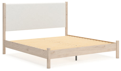 Angled view of Cadmori king upholstered panel bed