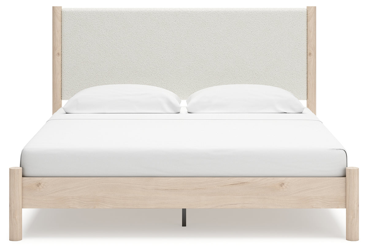 Head-on view of Cadmori king upholstered panel bed