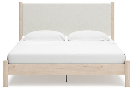Head-on view of Cadmori king upholstered panel bed