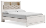 Side angle of Altyra White Queen Panel Bookcase Bed with LED lighting turned on