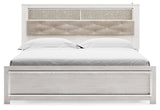 Altyra White King Panel Bookcase Bed head-on view showing shelf and chrome accents