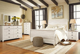 Willowton Whitewash Queen Sleigh Bed angled with natural light